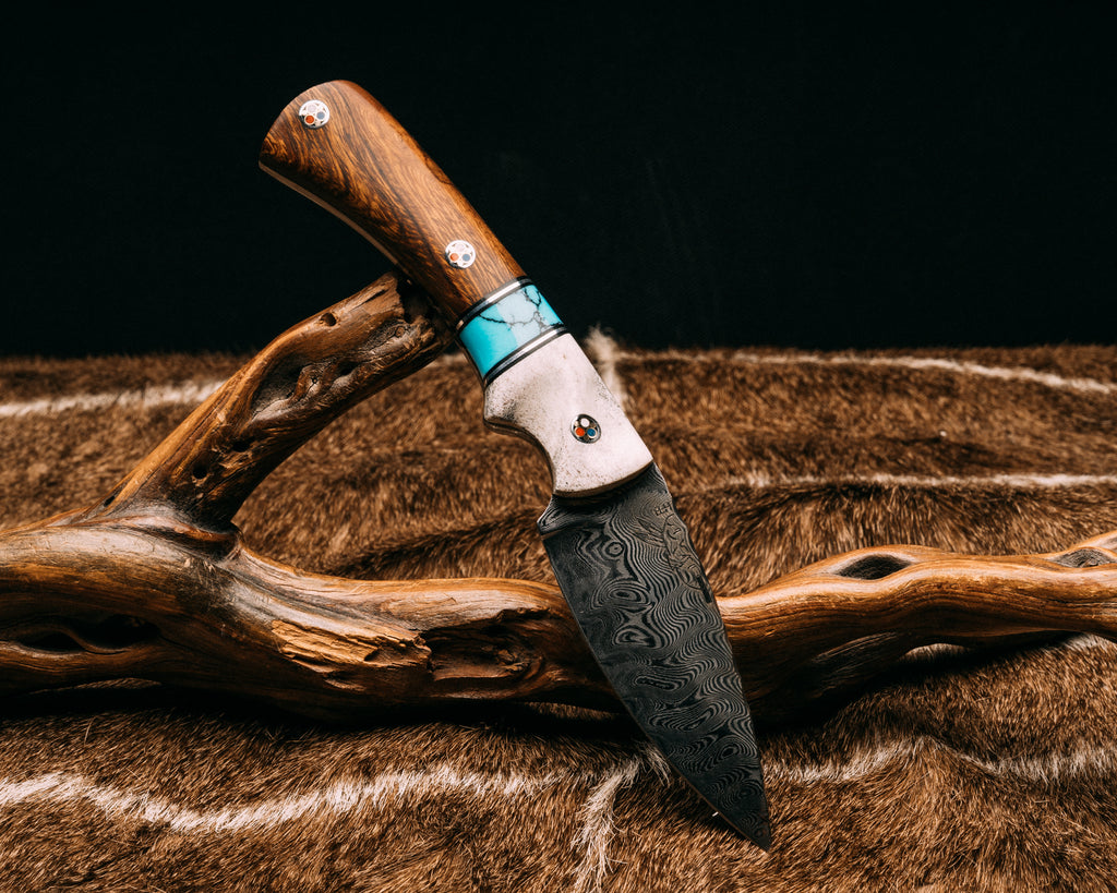 Storm Breaker Damascus - CO Elk, Black & Brass Pin Striping, Turquoise w/ Black Web Tru Stone, Desert Ironwood, Patriot Mosaic Pins, Contoured Grip.