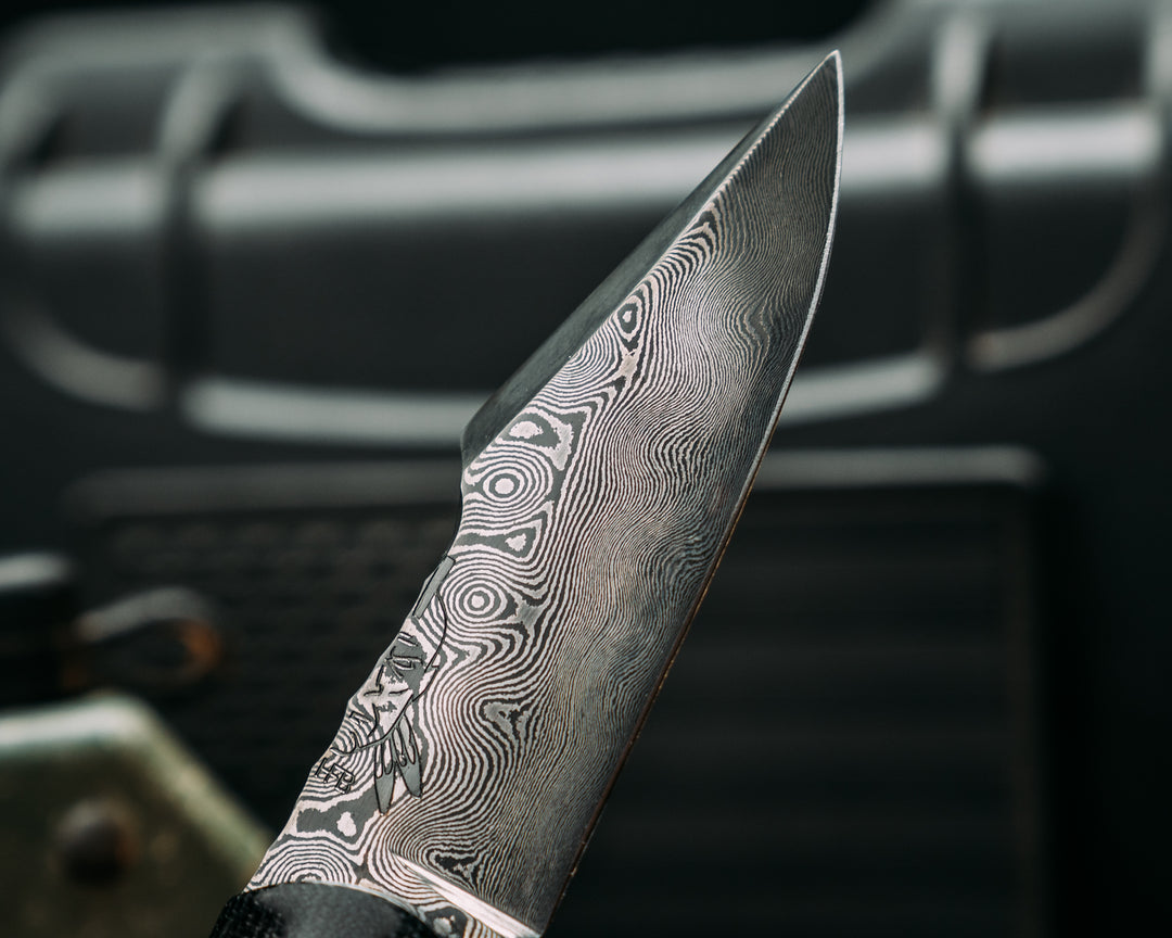 Widow Maker Jr- Baker Forge Raindrop Damascus- Black Canvas Miacrta, Black G10, White G10 and Aluminum Pin Striping, Black with White Web Tru-stone Split, Hawaiian Curly Koa, Mosaic Pins, Textured Grip
