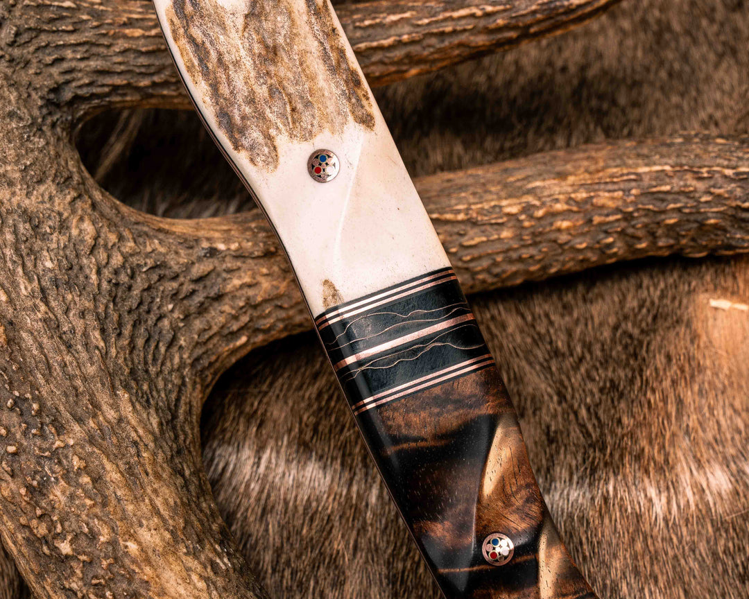 Bleeding Heart Hawk- Baker Forge Random Pattern CopperMai- Elk Antler, Black G10 and Copper Pin Striping, Raffir Noble Curly Copper Split, Hawaiian Curly Koa Copper Patriot Mosaic Pins, Textured Grip