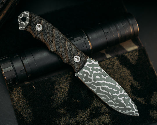 Disaster Jr -  Black Canvas Micarta, Lizard Camo Cerakote, Ti Torx Bolts, Iron Grip.