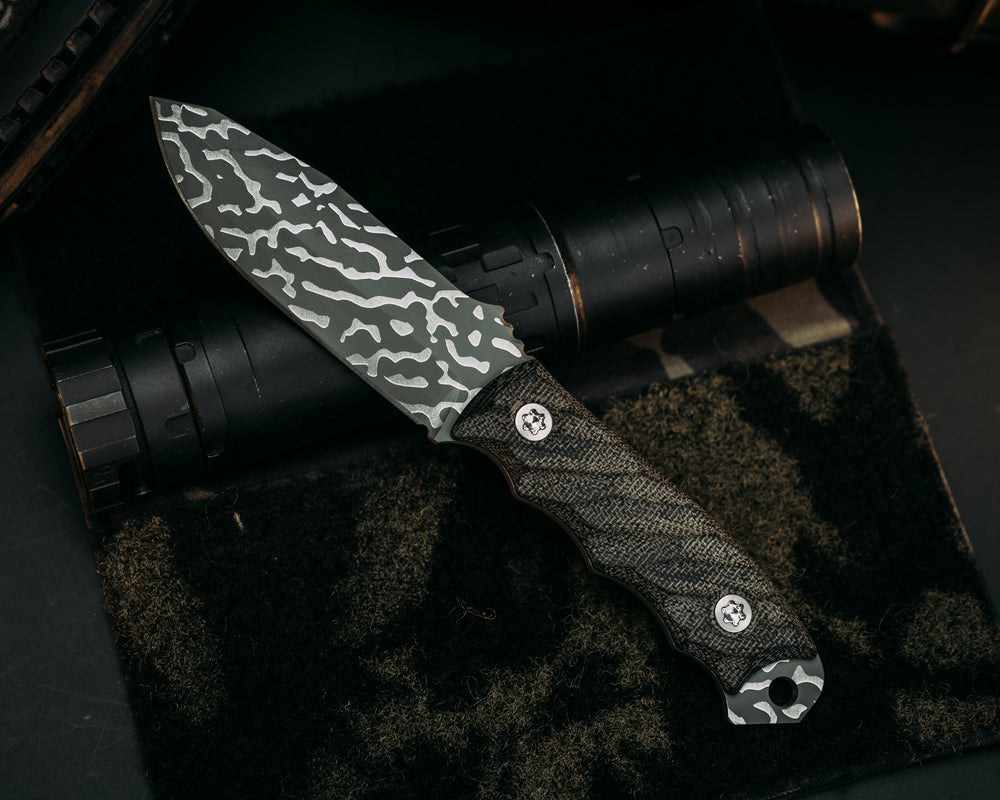 Disaster Jr -  Black Canvas Micarta, Lizard Camo Cerakote, Ti Torx Bolts, Iron Grip.