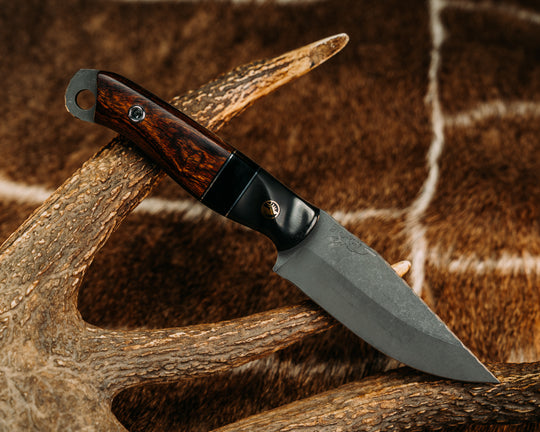 Crow Jr - Carbon Fiber Sourced From Prosthetic Leg, Black G10 & Aluminum Pin Striping, Bison's Horn Split, Desert Ironwood, Brass Elk Pin, Titanium Screw Pin Sourced From Prosthetic Leg, Contoured Grip. 01