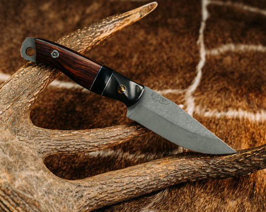 Crow Jr - Carbon Fiber Sourced From Prosthetic Leg, Black G10 & Aluminum Pin Striping, Bison's Horn Split, Desert Ironwood, Brass Elk Pin, Titanium Screw Pin Sourced From Prosthetic Leg, Contoured Grip. 02
