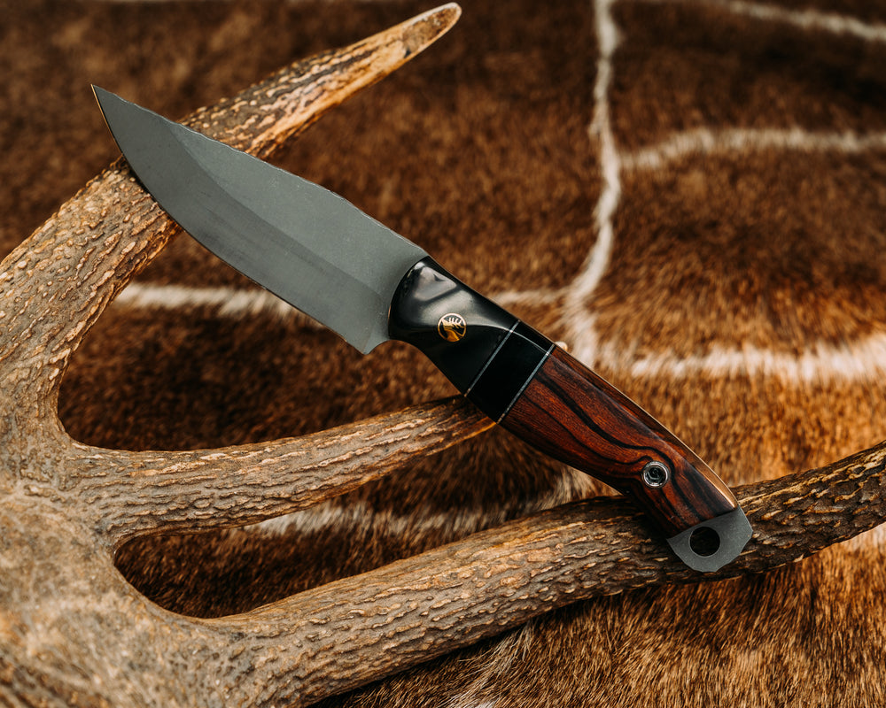 Crow Jr - Carbon Fiber Sourced From Prosthetic Leg, Black G10 & Aluminum Pin Striping, Bison's Horn Split, Desert Ironwood, Brass Elk Pin, Titanium Screw Pin Sourced From Prosthetic Leg, Contoured Grip. 02