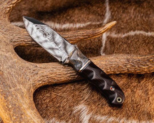 Disaster Cub- Baker Forge Ice Storm Damascus- Dinosaur Bone, Aluminum, Black G10 and Brass Split, Redwood, 1/8" Patriot Mosaic Pin, Patriot Mosaic Pin, Aluminum Lanyard Pin, Textured Grip